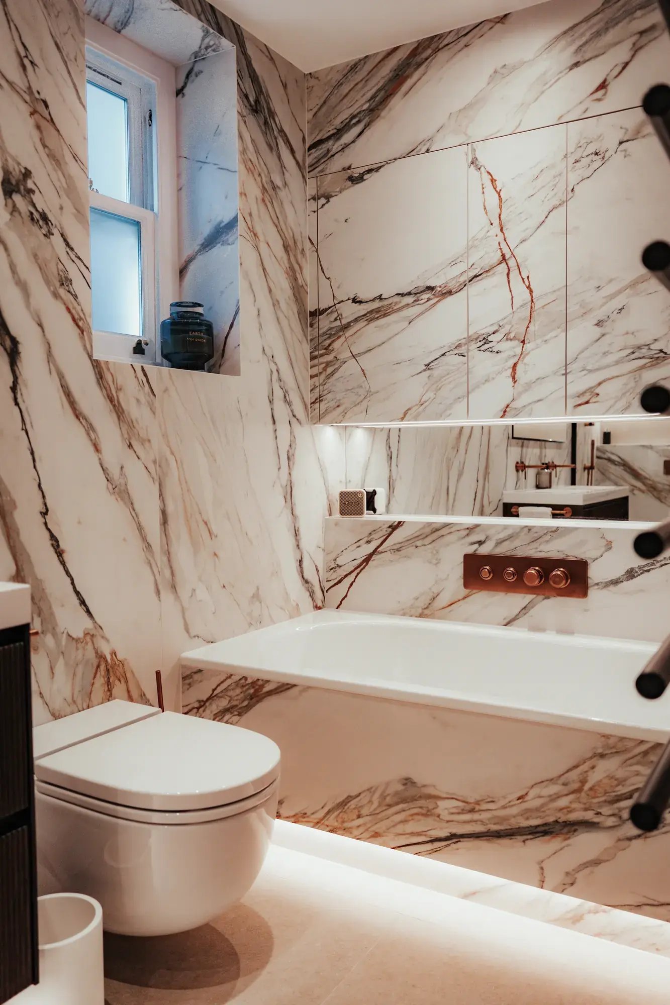kallums-luminous-heaven-london-bathroom-bath-window-marble-walls-towel-bars